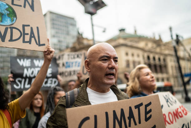 istock Protesters holding signs during a demonstration in the street 1385769292