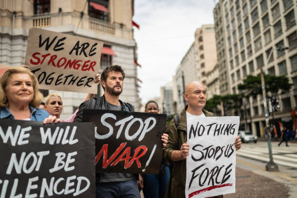 istock Protesters holding signs during a demonstration in the street 1385769320