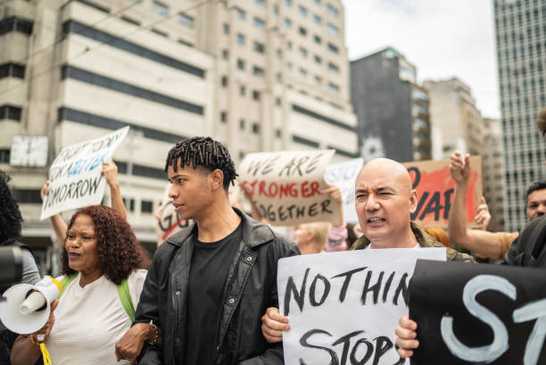 istock Protesters holding signs during a demonstration in the street 1385769323