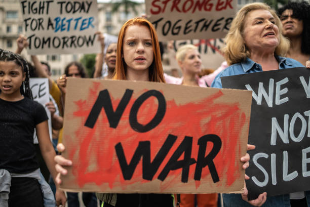 istock Protesters holding signs during a demonstration in the street 1385769331