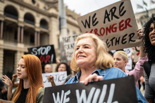 istock Protesters holding signs during a demonstration in the street 1385769337