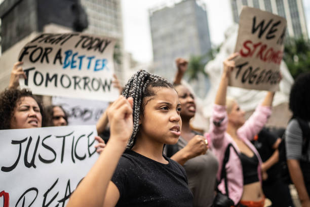 istock Protesters holding signs during a demonstration in the street 1385769349