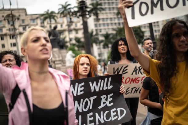 istock Protesters holding signs during a demonstration in the street 1385769367