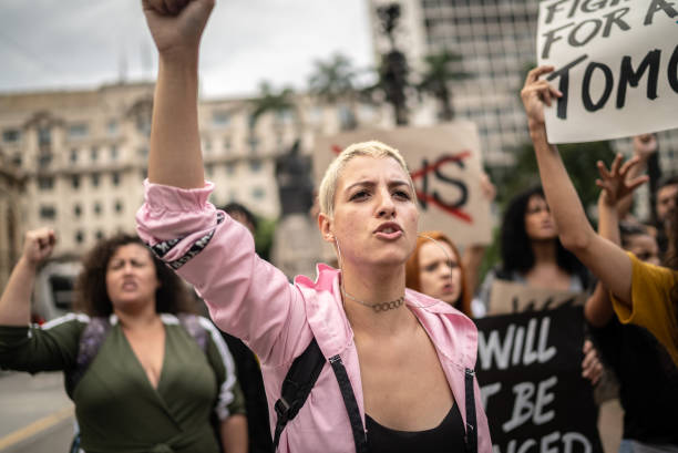istock Young woman marching during on a demonstration for peace 1385771090