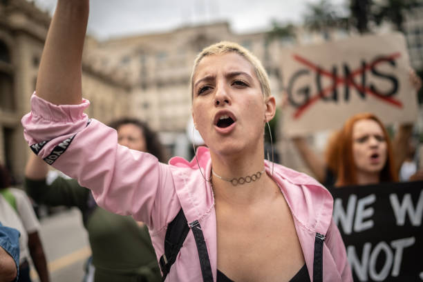 istock Young woman marching during on a demonstration for peace 1385771092