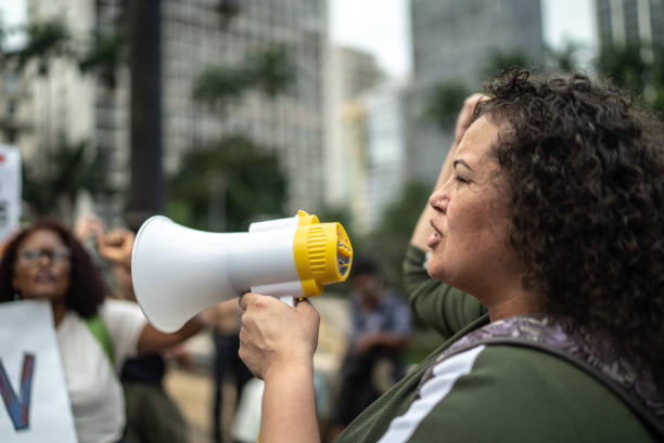 istock Woman leading protests on a demonstration for equal rights 1385771174