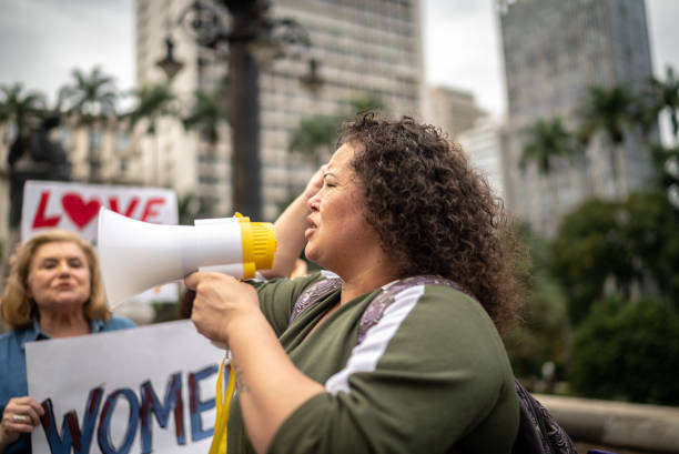 istock Woman leading protests on a demonstration for equal rights 1385771178