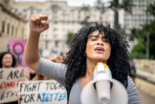 Woman leading a demonstration using a megaphone