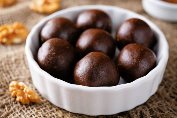istock Dates walnuts chocolate raw balls in a plate 1385771570