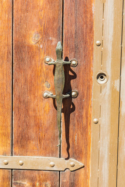 istock Bronze door handle in the shape of a lizard. 1385771596