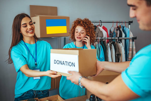 istock Charity workers placing food into donation boxes 1385773270
