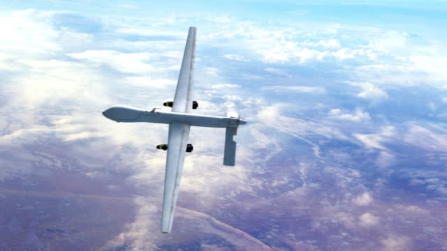 New Generation Unmanned Combat Aerial Vehicle Flying Over The Clouds.