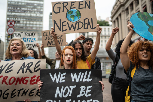 Protesters holding signs during on a demonstration for environmentalism