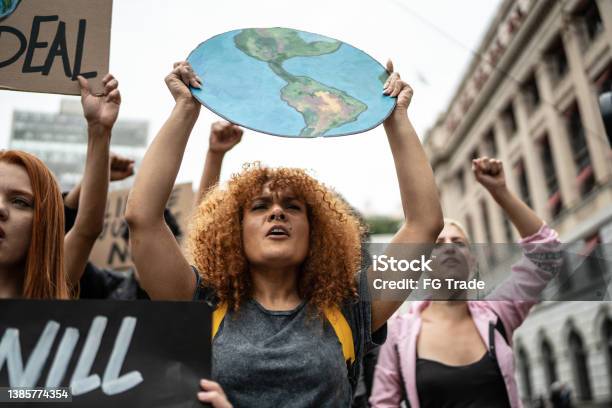 Protesters Holding Signs During On A Demonstration For Environmentalism Stock Photo - Download Image Now