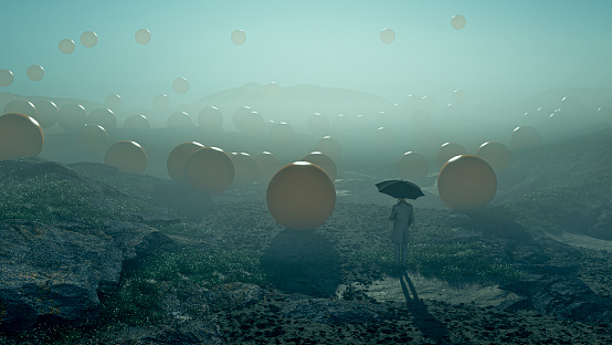 Surreal image of man standing in the field with falling spheres - this is entirely 3D generated image.