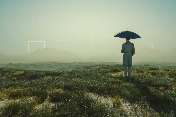 istock Man standing in meadow with distant passages glowing in mid air 1385778700
