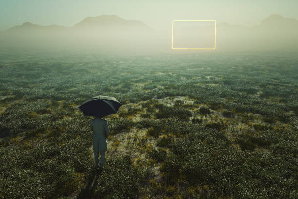 istock Man standing in meadow with distant passages glowing in mid air 1385778743