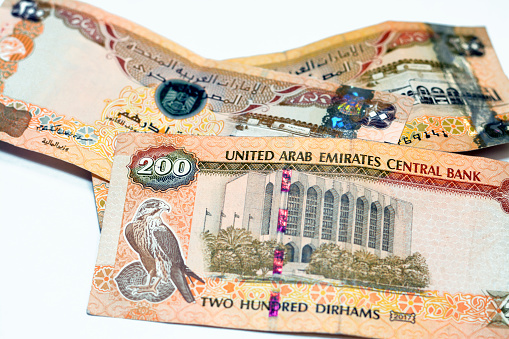 200 AED two hundred Dirhams banknote of United Arab Emirates, obverse side has Zayed Sports City Stadium and Sharia Court building, reverse side has Central Bank of the UAE and a falcon image