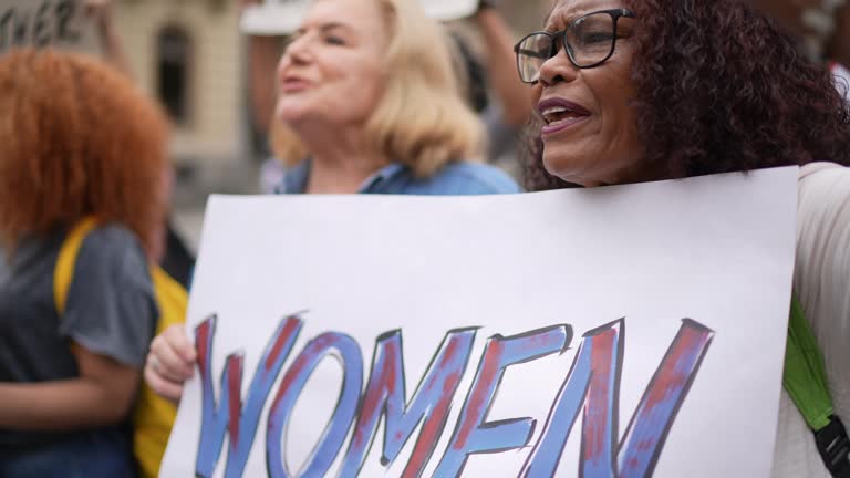 Women holding signs during a demonstration in the street