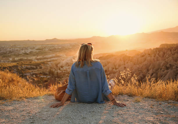 istock Woman enjoying sunset 1385781695