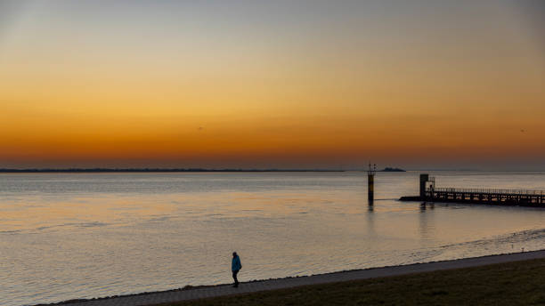 Bremerhaven, Germany - Mar 5th 2022: A classical sunset over Weser river in Bremerhaven, Germany.