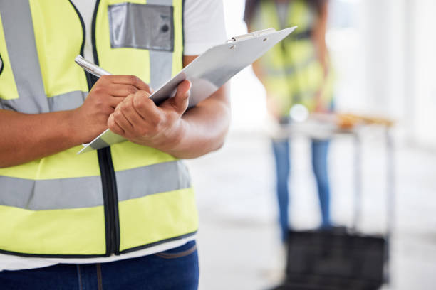 istock Cropped shot of an unrecognisable contractor standing inside and using a clipboard 1385786922