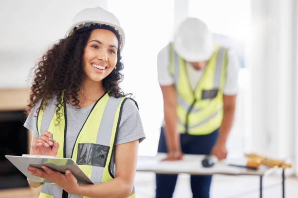 istock Shot of an attractive young contractor standing inside and using a clipboard 1385786939