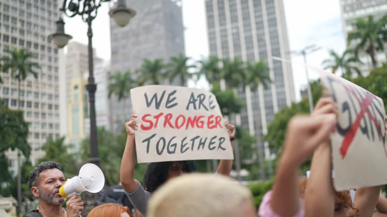 Protestors holding signs during a demonstration in the street