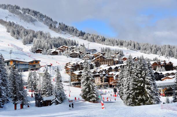 Courchevel ski resort with it’s beautiful chalets in winter Courchevel,French alps,France. Courchevel ski resort by winter with it’s beautiful chalets on the slopes. Courchevel ski resort is a famous ski resort and one of the best in the world. courchevel stock pictures, royalty-free photos & images