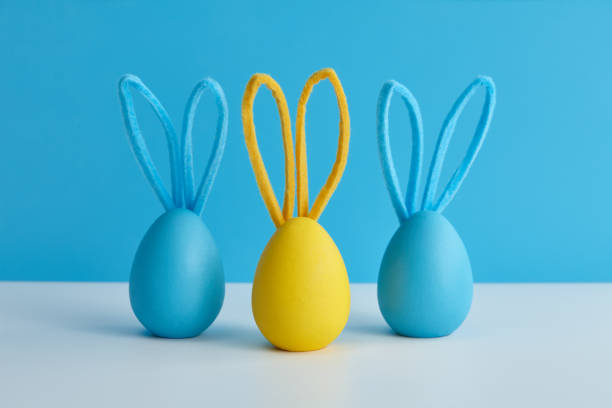istock Blue and yellow Easter eggs with bunny ears, holiday decoration 1385788517