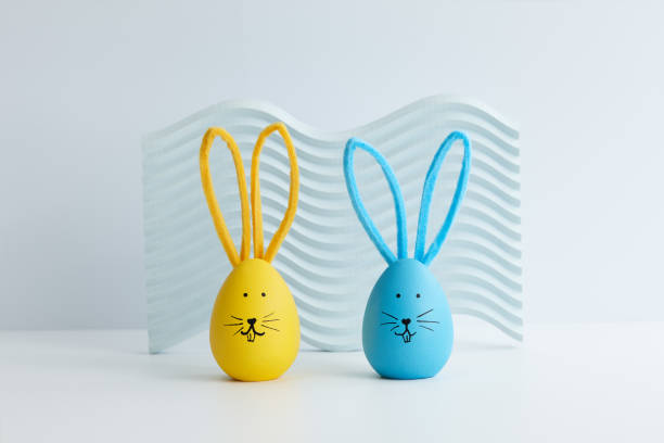istock Blue and yellow Easter eggs with bunny faces, holiday decoration 1385788540