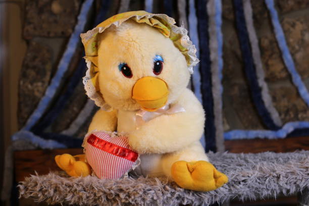 istock Stuffed baby chicken holding a heart 1385789751