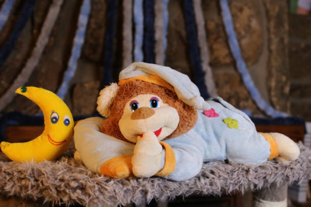 istock Sleepy teddy bear wearing classic pajamas 1385789823