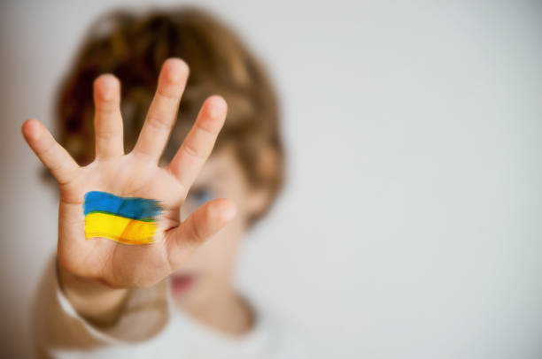 STOP Russian Invasion of Ukraine - Conceptual Symbol Young Boy Showing Painted Ukraine Flag donetsk photos stock pictures, royalty-free photos & images