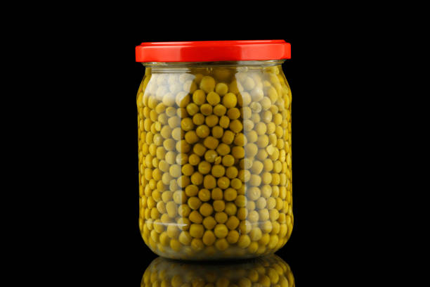 istock Jar with green peas black background 1385795280