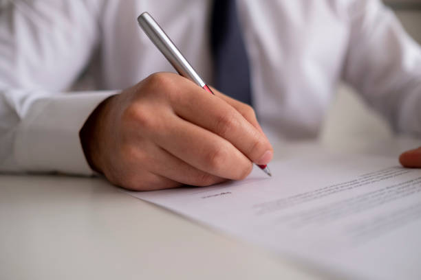 signing official document - desk corporate business business paper imagens e fotografias de stock