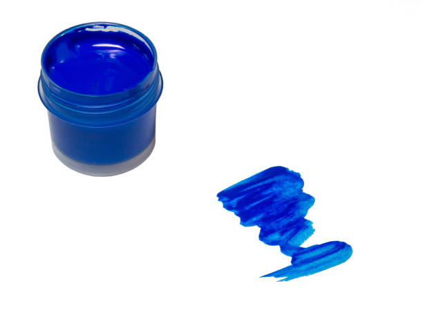 istock blue acrylic in a jar. drops of paint on the table. 1385796591