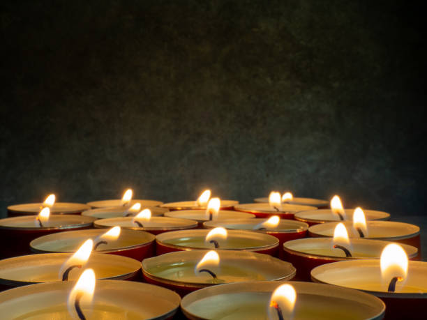 istock Lots of small lit candles. Dark mysterious atmosphere. 1385796616