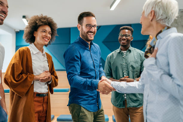 Handshake for the new agreement Happy businessman shaking hands with colleague on a meeting in the office. employee introduction stock pictures, royalty-free photos & images