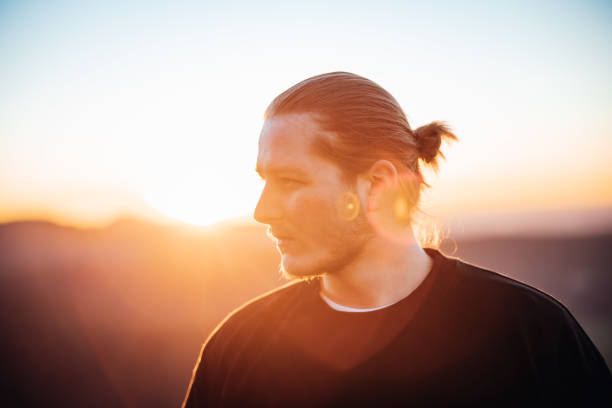 istock Young Man Looking Away Outdoors Sunset Millennial Portrait 1385799642