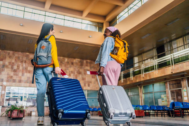 istock Women with suitcases at train station 1385800812