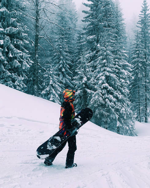 young  snowboarder woman at ski resort
