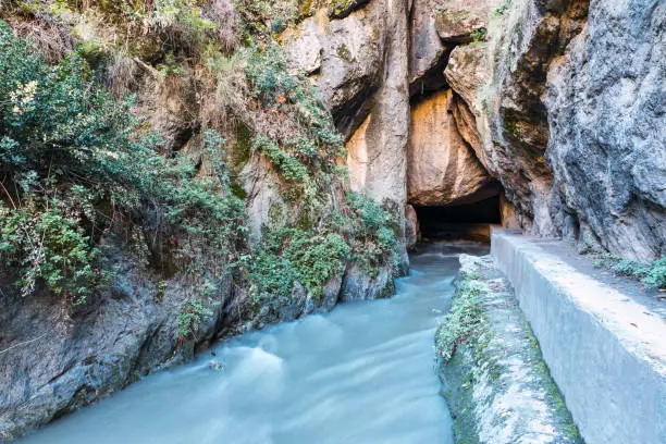 Entrance of the river in the cave between mountains in the route of the river Monachil, in Los Cahorros, Granada, Spain.