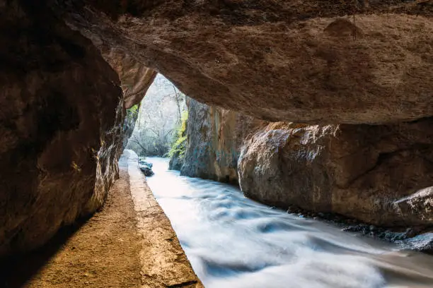 Exit from the cave between mountains on the route of the Monachil river, in Los Cahorros, Granada, Spain.