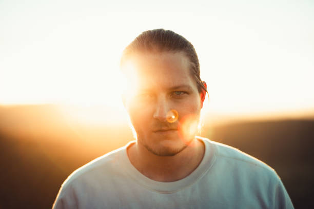 Cool Looking Young Man Outdoors at Sunset Millennial Generation Portrait stock photo