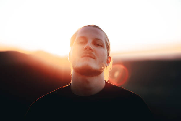 istock Cool Looking Young Man Outdoors at Sunset Millennial Generation Portrait 1385808225