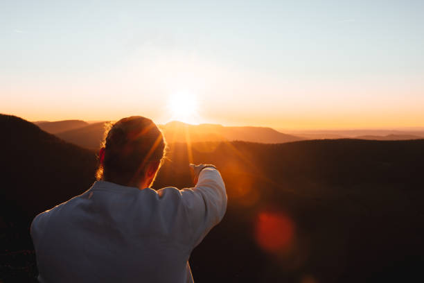 istock Pointing towards the sun at sunset from Mountain Top 1385808735