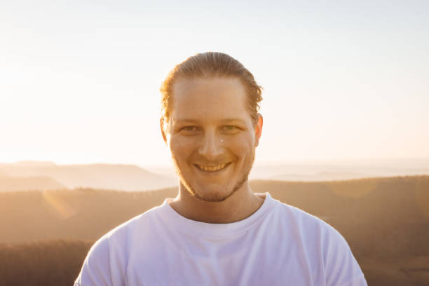 istock Happy Smiling Young Man Outdoors Sunset Portrait 1385809257