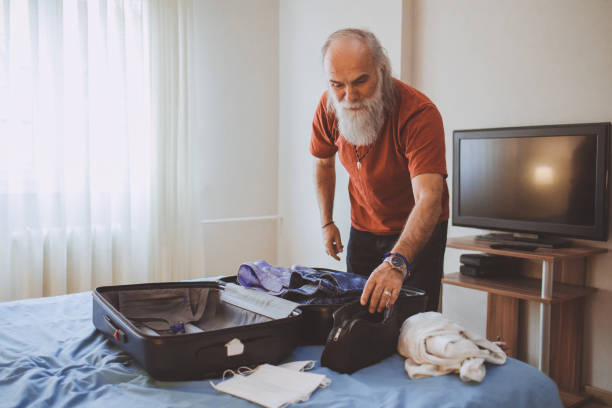 istock A mature man packing for a trip 1385825294