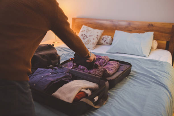 un homme qui fait ses valises pour un voyage - vanity business business person men photos et images de collection